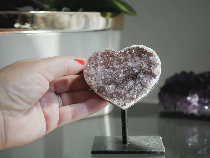 Rainbow Amethyst Heart crystal on metal stand with purple and orange mineral inclusions