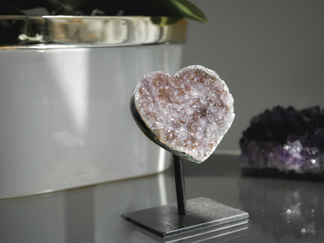 Heart-shaped crystal on a stand with a blurred background